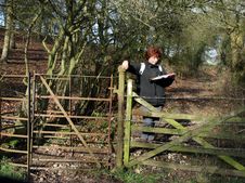 Lady Hiker Reading A Map By A Kissing Gate Royalty Free Stock Photos
