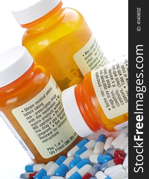 Bottles of Pills Surrounded by Capsules on White Background. Bottles of Pills Surrounded by Capsules on White Background