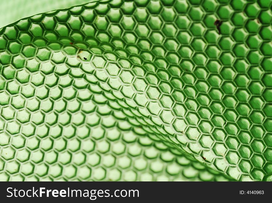 Marco shot of a bee hive shaped background in green. Marco shot of a bee hive shaped background in green