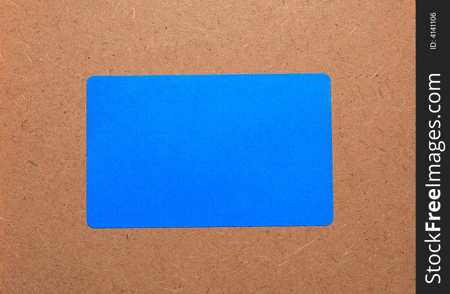 Blue paper on a wooden background.Note paper. Card