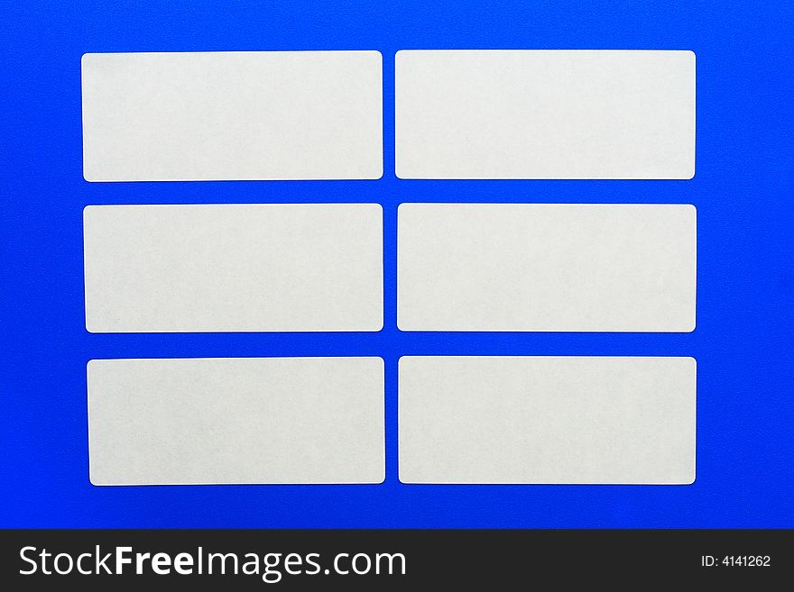 White cards on a blue background.White paper.