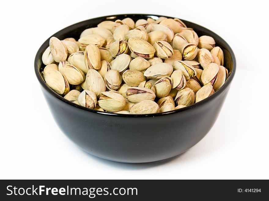 Black bowl full of pistachios