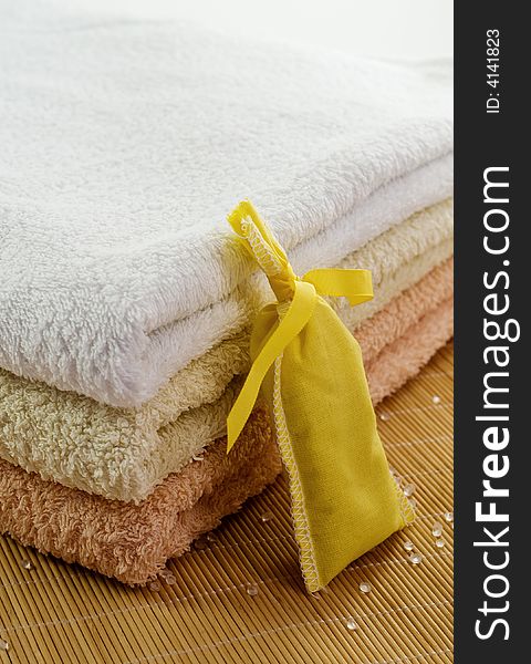 Towels in gentle colors with scent yellow bag and salt pearls. Towels in gentle colors with scent yellow bag and salt pearls