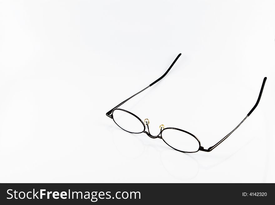 Reading glasses with reflection on white background