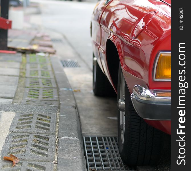 Red vintage car parking by the curbside. Red vintage car parking by the curbside