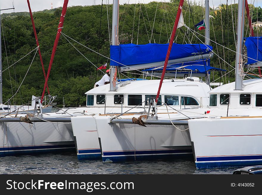 Charter catamaran sailboats docked and waiting for passengers. Charter catamaran sailboats docked and waiting for passengers