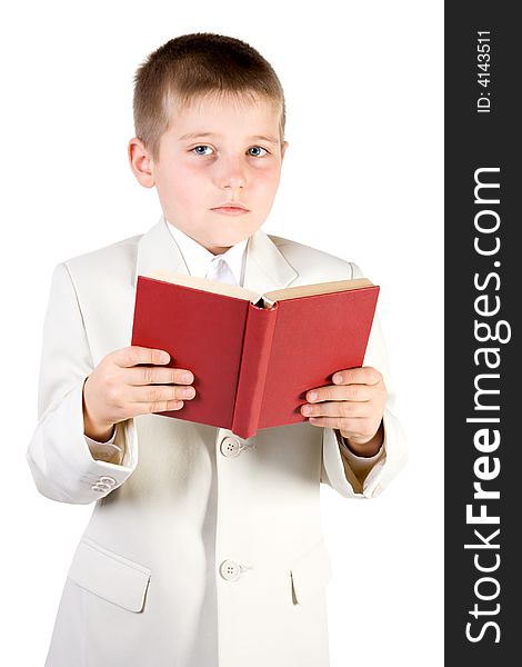 Well-dressed boy read red book and looking in camera. Isolated on white. Well-dressed boy read red book and looking in camera. Isolated on white