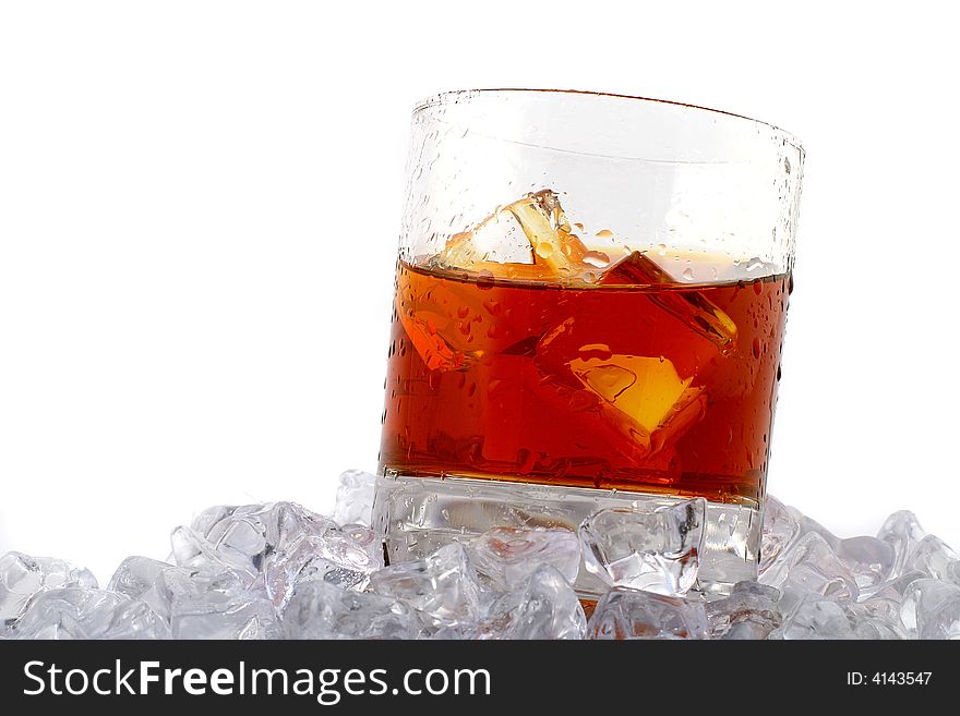 Glass of whiskey with ice cubes on white background. Glass of whiskey with ice cubes on white background