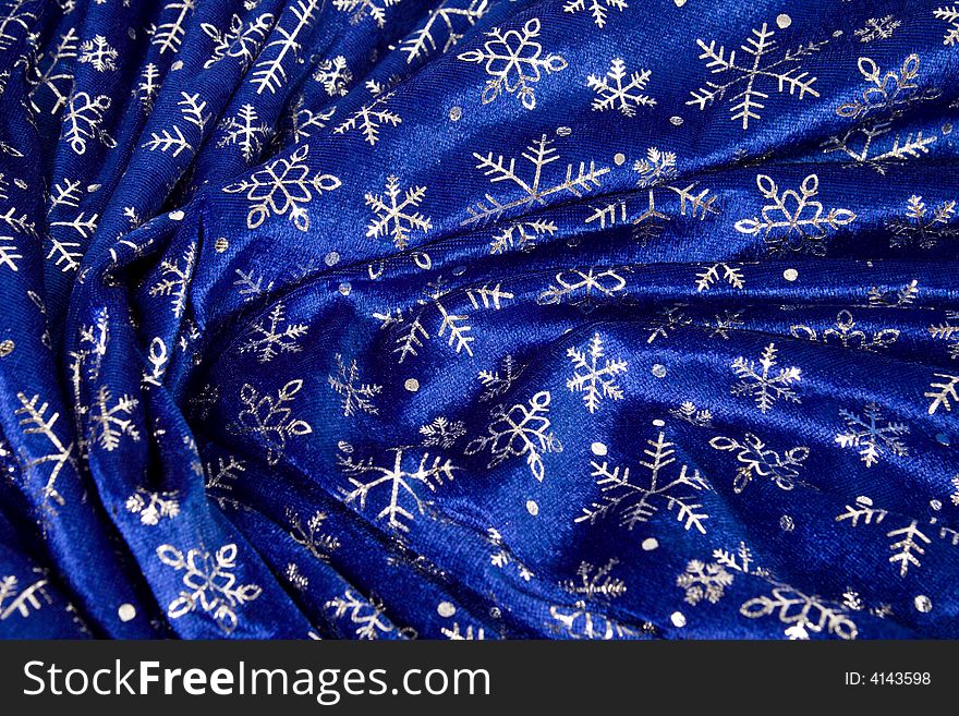 Close-up crumple blue cloth with snowflakes