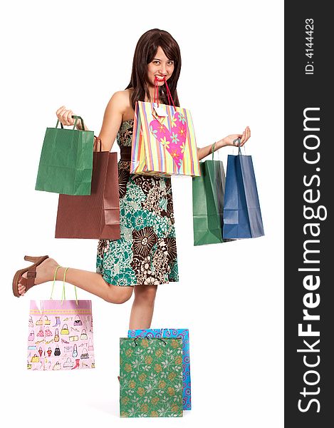 Beautiful shopping girl overloaded with shopping bags