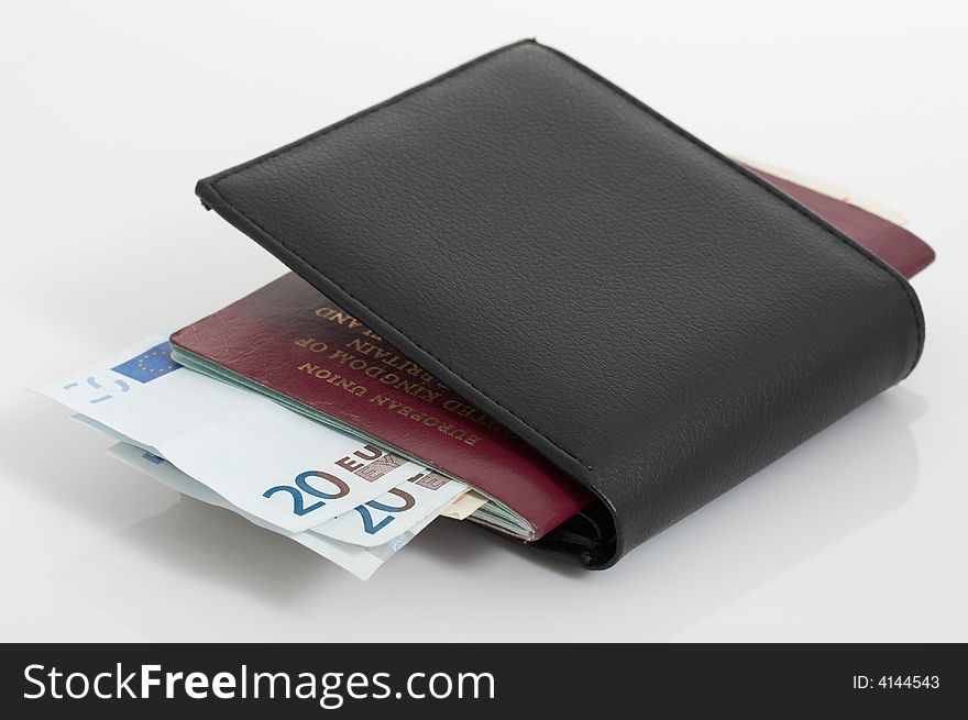 A passport and a wallet with euro bills. A passport and a wallet with euro bills