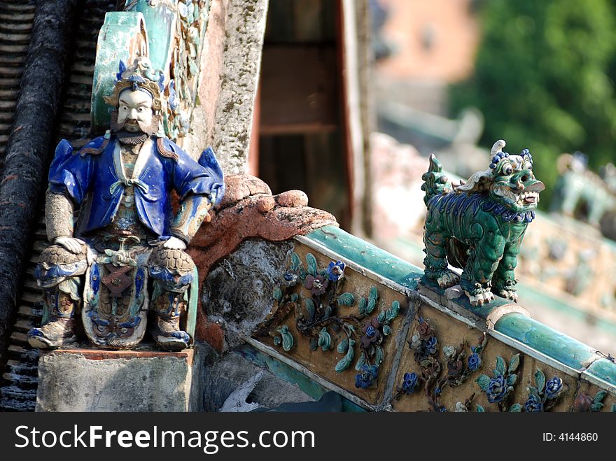 Ceramic sculpture of the fire of god，on the ridge of traditional southern chinese houses or temples.Ancestral temple,foshan,Guangdong,China,Asia. Ceramic sculpture of the fire of god，on the ridge of traditional southern chinese houses or temples.Ancestral temple,foshan,Guangdong,China,Asia