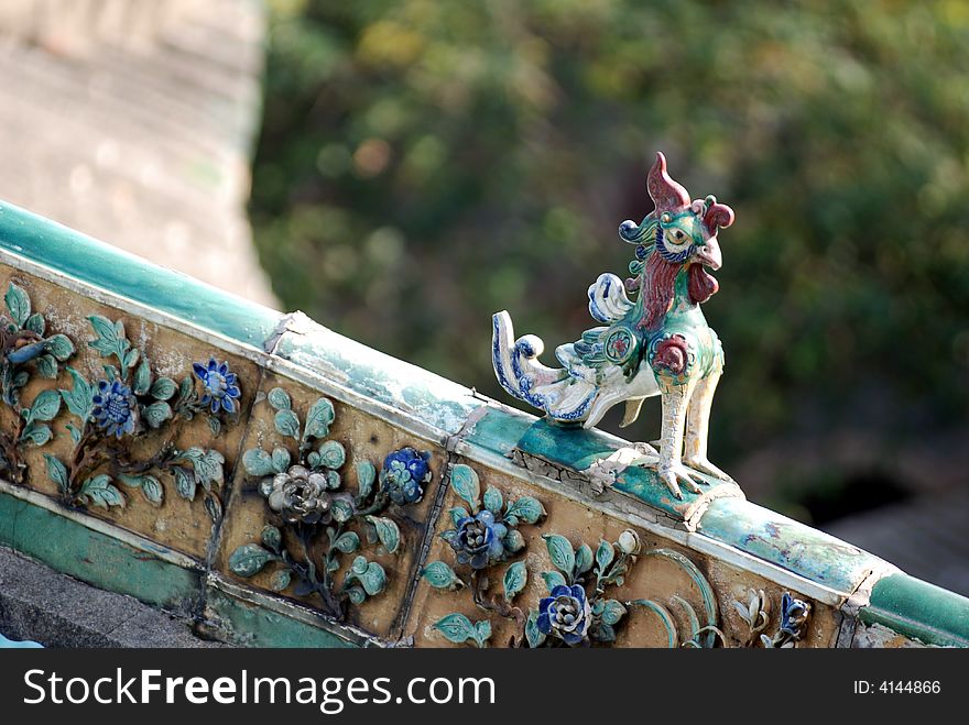 Ceramic phoenix on the ridge of the traditional houses or temples in Guandong ,south china ,asia. symobole of auspicious