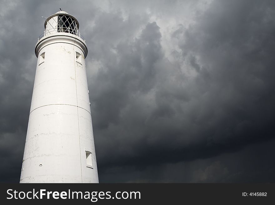 A lighthouse against an approaching storm