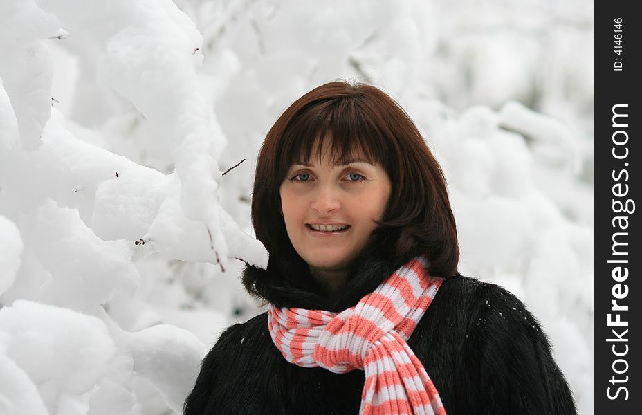 Portrait of the woman on a background of snow branches