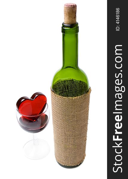 Glassy heart in a glass of wine and the bottle isolated at the white background