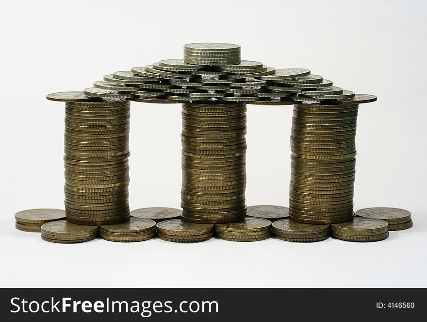 Close-up of multicolor coins making as a house on the white background (isolated on white). Close-up of multicolor coins making as a house on the white background (isolated on white)