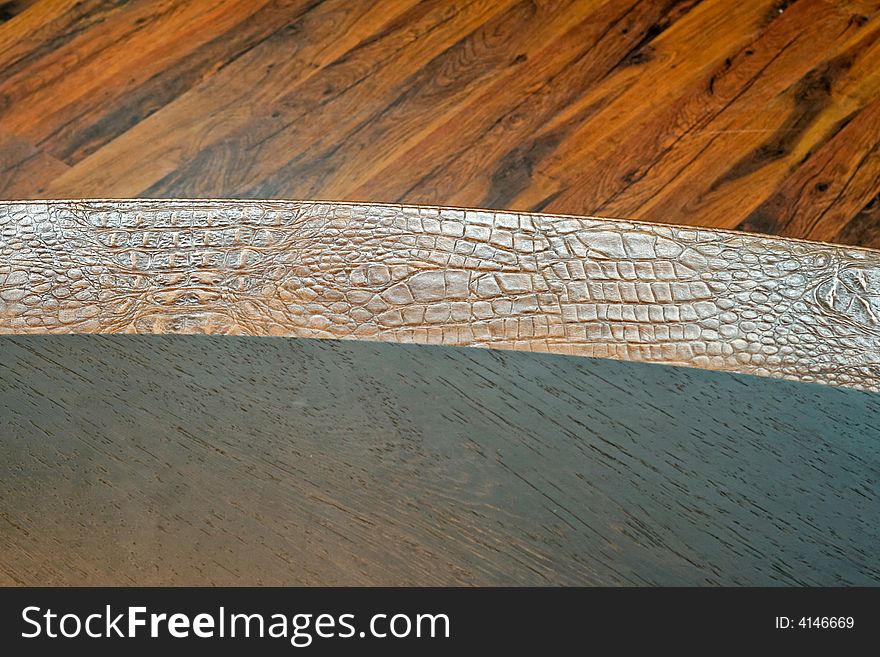 Real crocodile leather pattern and wooden background. Real crocodile leather pattern and wooden background