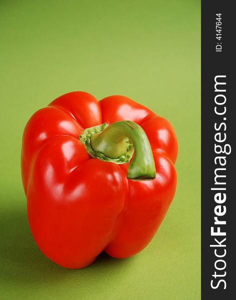 Red pepper on green background