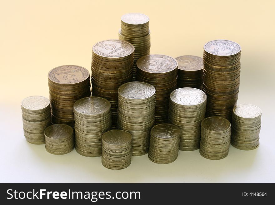 Close-up of multicolor coins stacks on the white background (isolated on white)