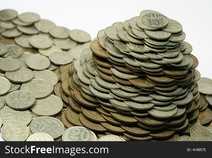 Close-up of pile of coins on the white background (isolated on white)