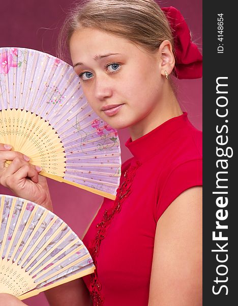 Dancing with fans on a red background