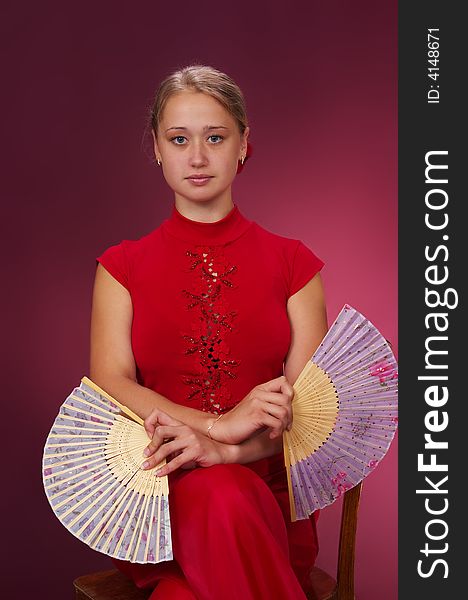 Dancing with fans on a red background