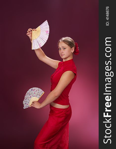 Dancing with fans on a red background