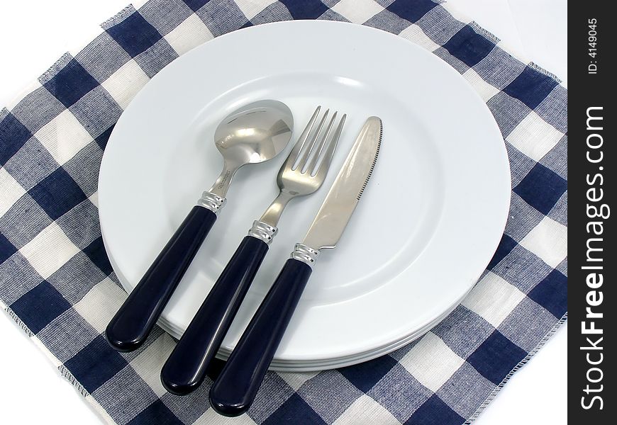 Served table plates fork spoon knife and serviette. Served table plates fork spoon knife and serviette