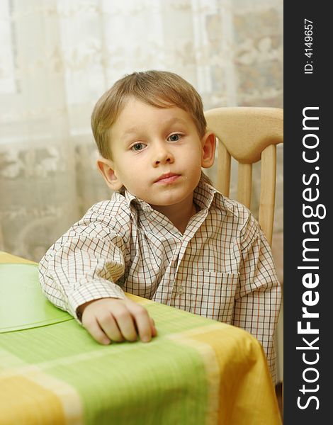 A 4 year old boy portrait at kitchen