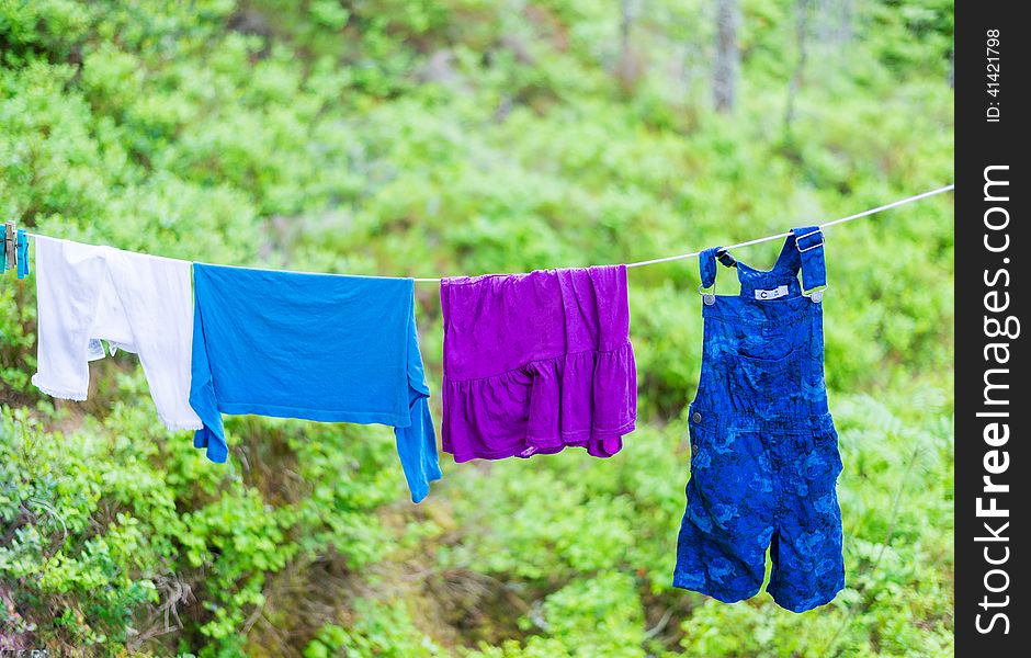 Child Clothes On Laundry Line In Woods