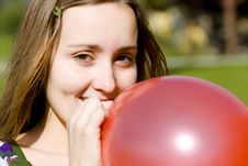 Young Woman Inflating Red Balloon Royalty Free Stock Image Young Woman Inflating Red Balloon Royalty Free Stock Image