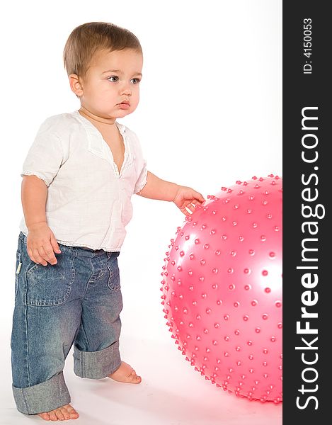 Thoughtful dark haired boy with pink fitness ball on white background. Thoughtful dark haired boy with pink fitness ball on white background