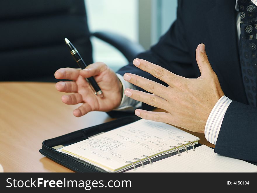 A businessman with pen doing gesticulation