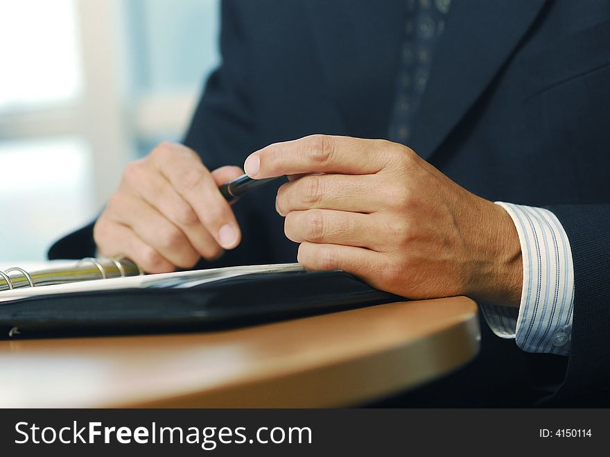 A businessman with pen doing gesticulation