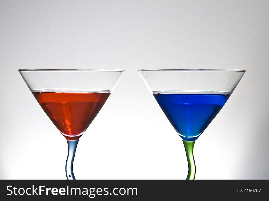 Red and blue martinin on a white background that fades to gray