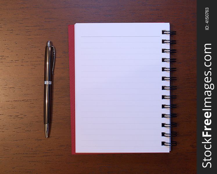 Open notebook with pen next to it