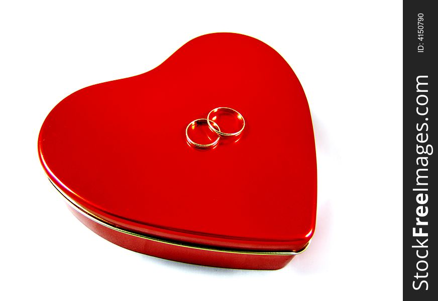 Red three-dimensional heart shape box with two golden rings isolated on white background. Good for Valentine's Day greeting card. Red three-dimensional heart shape box with two golden rings isolated on white background. Good for Valentine's Day greeting card.