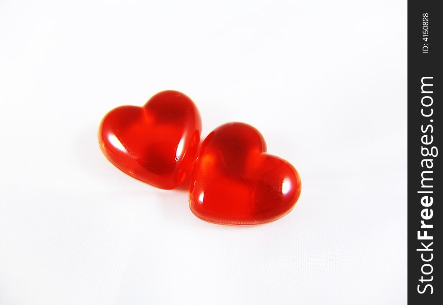Two red three-dimensional hearts isolated on white background. Two red three-dimensional hearts isolated on white background