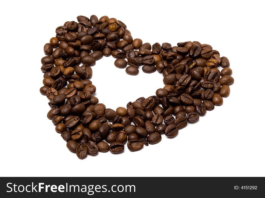 Heart made of coffee beans isolated at the white background. Heart made of coffee beans isolated at the white background