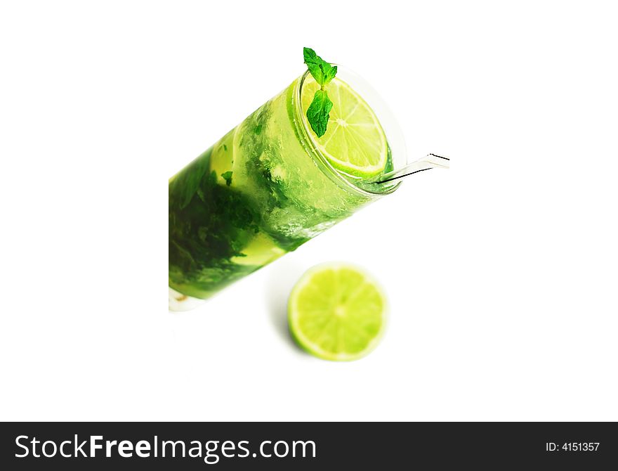 A majito with a lime segment and mint beside isolated on a white background. A majito with a lime segment and mint beside isolated on a white background