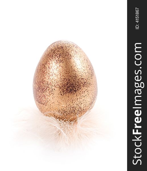 Golden-painted easter egg in white feathers isolated on white. Golden-painted easter egg in white feathers isolated on white