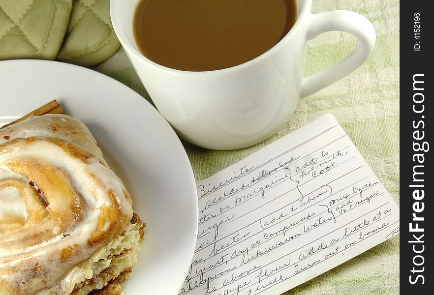 Cinnamon Roll with Recipe and a cup of coffee. Cinnamon Roll with Recipe and a cup of coffee.