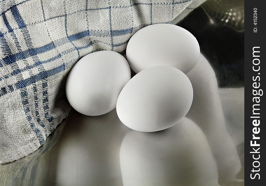 Three Eggs reflecting in a Metal Dish. Three Eggs reflecting in a Metal Dish.