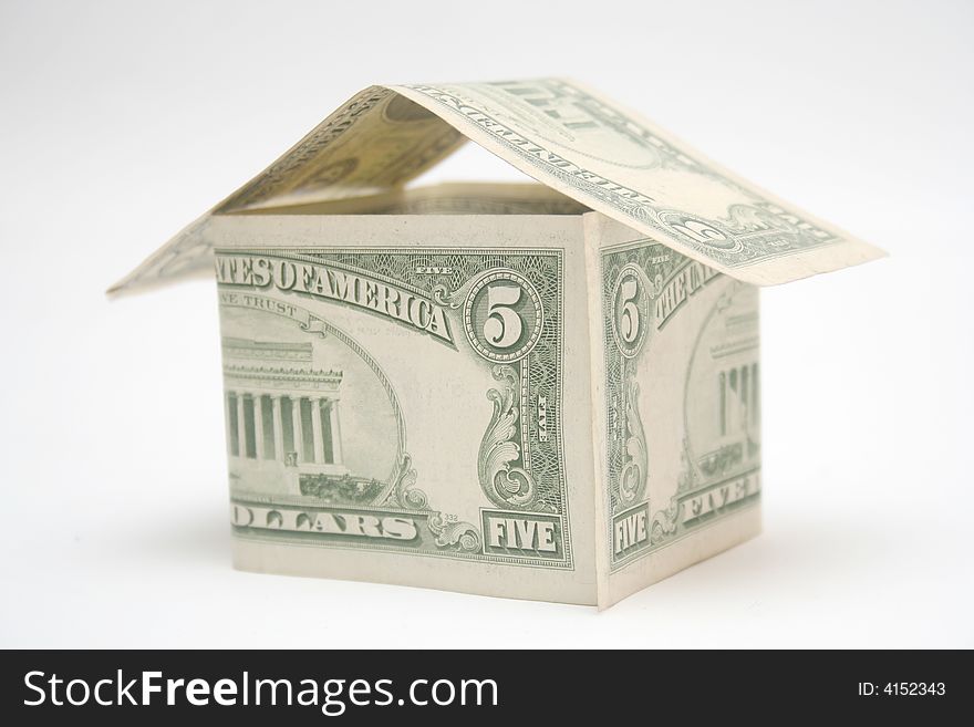 House made from dollar bills on light background. House made from dollar bills on light background