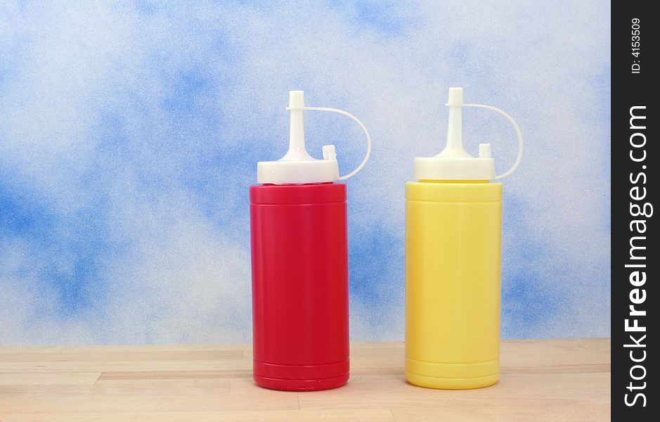 Ketchup and Mustard on Blue Textured Background