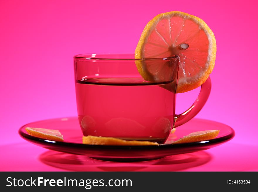 It is a cup with a lemons on a pink background. It is a cup with a lemons on a pink background.