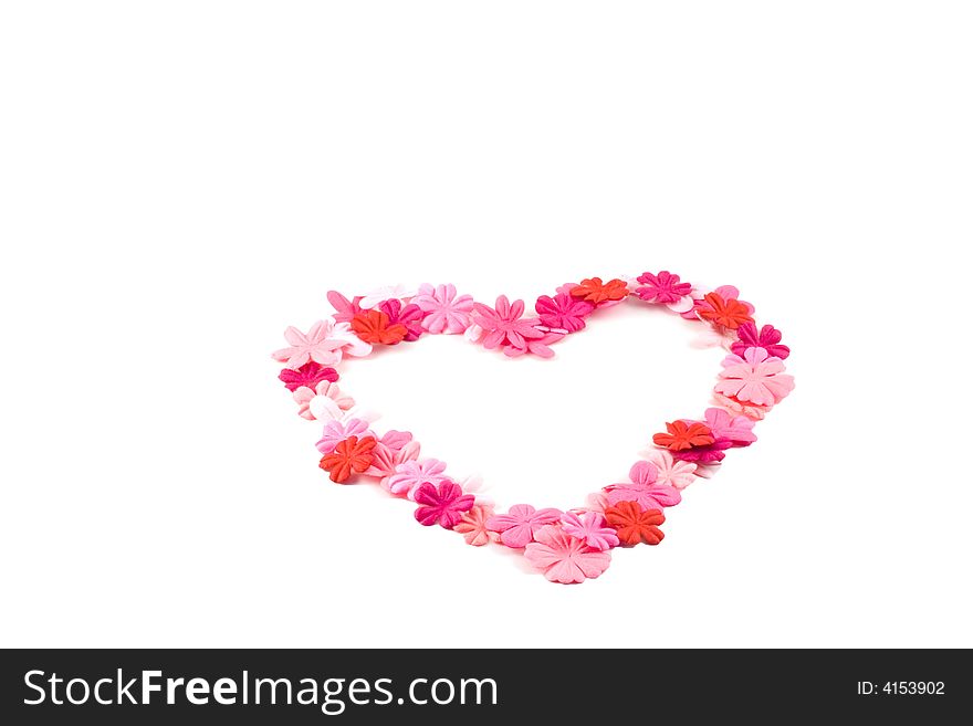 A pretty heart made out of red and pink flowers on a white background. A pretty heart made out of red and pink flowers on a white background.