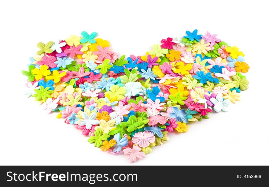 A pile of spring hued flowers shaped into an attactive heart shape on a white background. A pile of spring hued flowers shaped into an attactive heart shape on a white background.