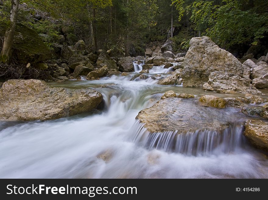Mountain river with water flowing over rocks